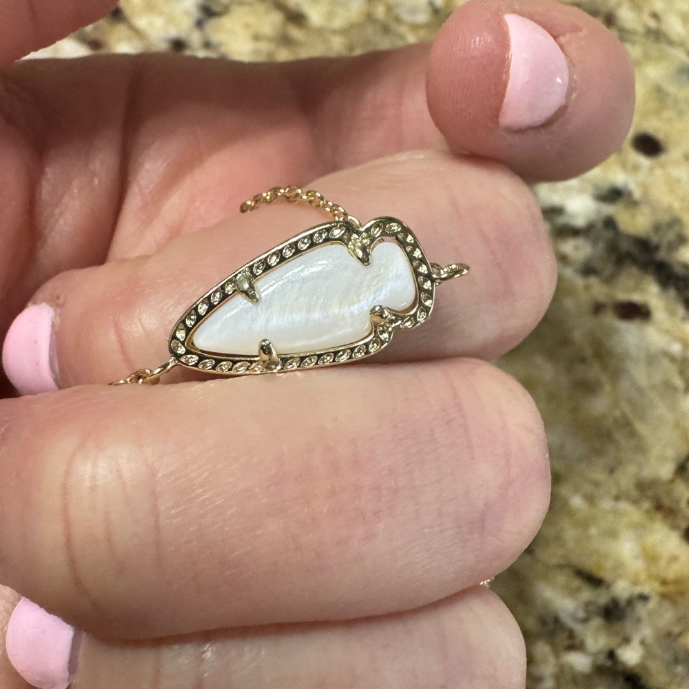 Kendra Scott dainty choker style mother of pearl arrowhead necklace.